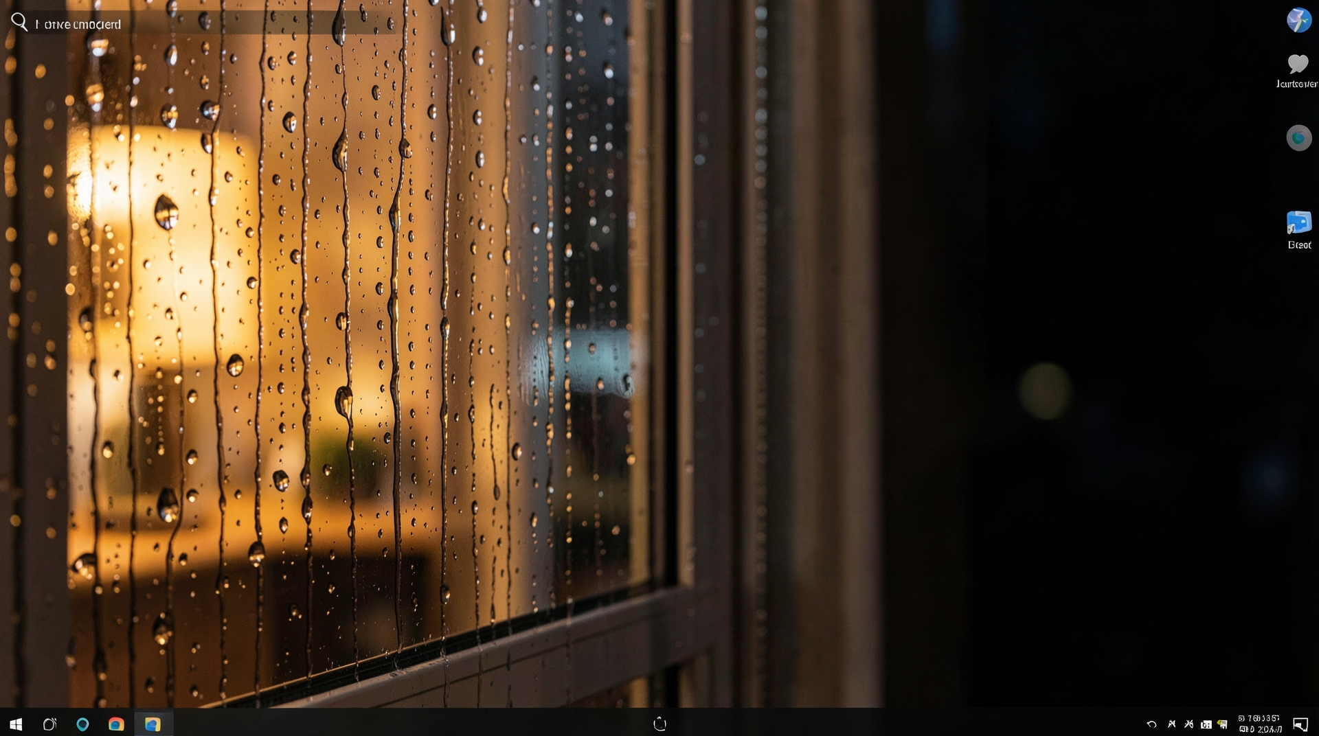 A rainy window at night with cozy lighting