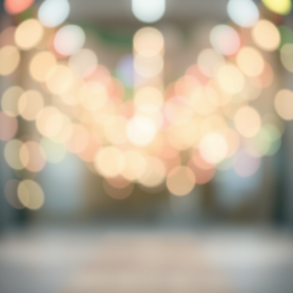 A blurred, colorful light display with a soft focus, set against a pastel-colored background with a subtle white and gray gradient.