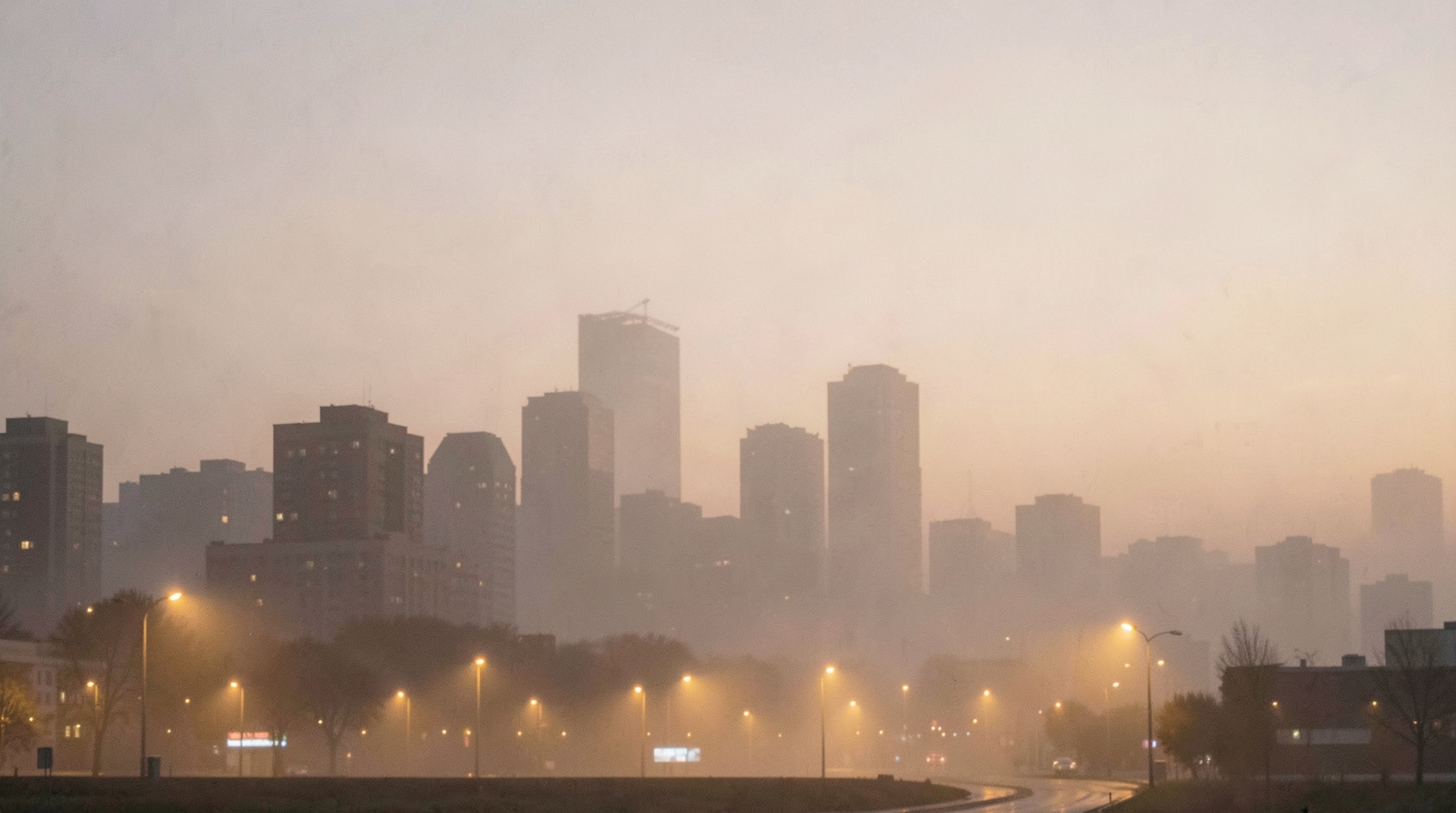 Foggy Cityscape at Dusk with Streetlights