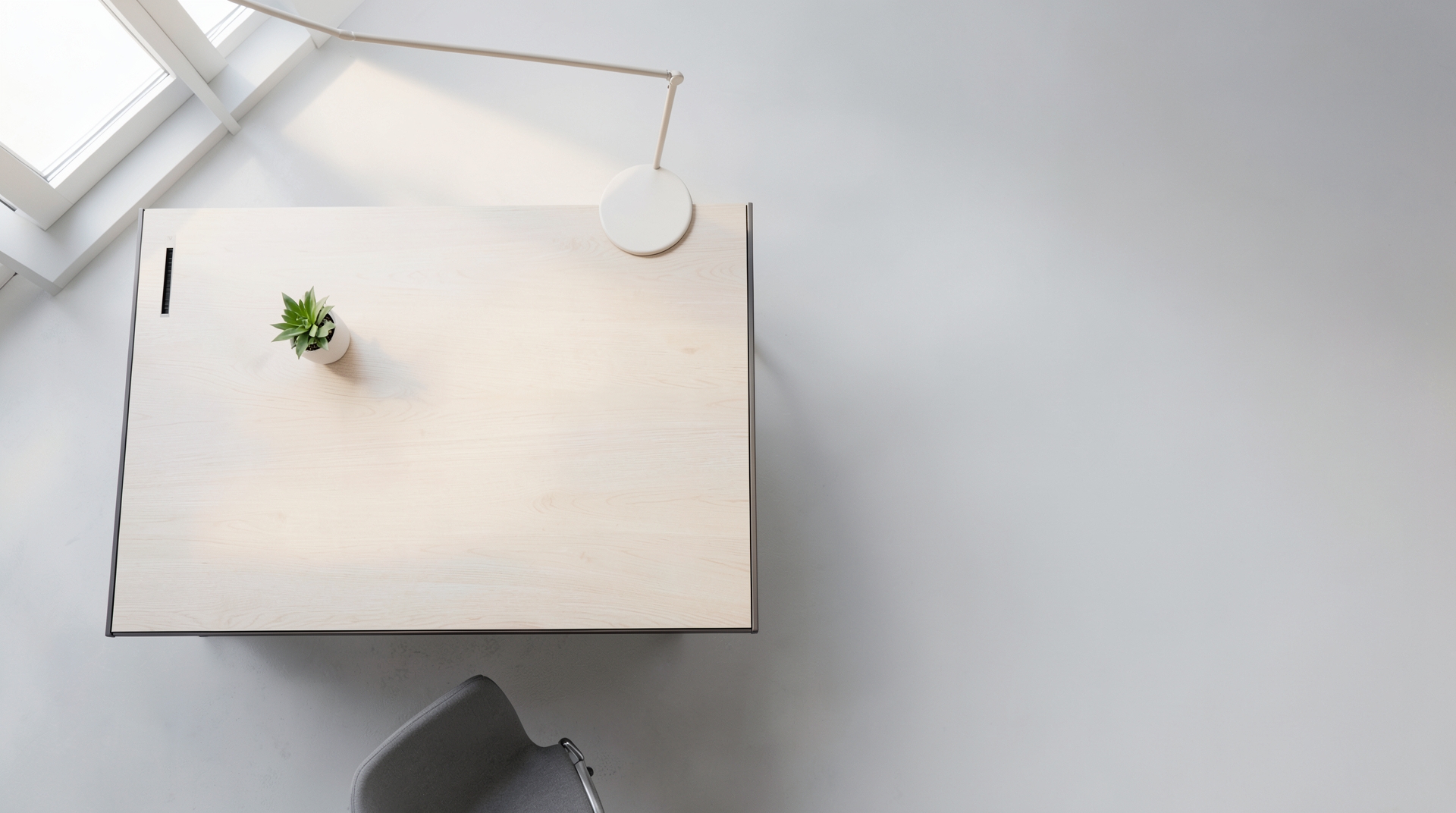 Minimalist office desk with empty space viewed from above.