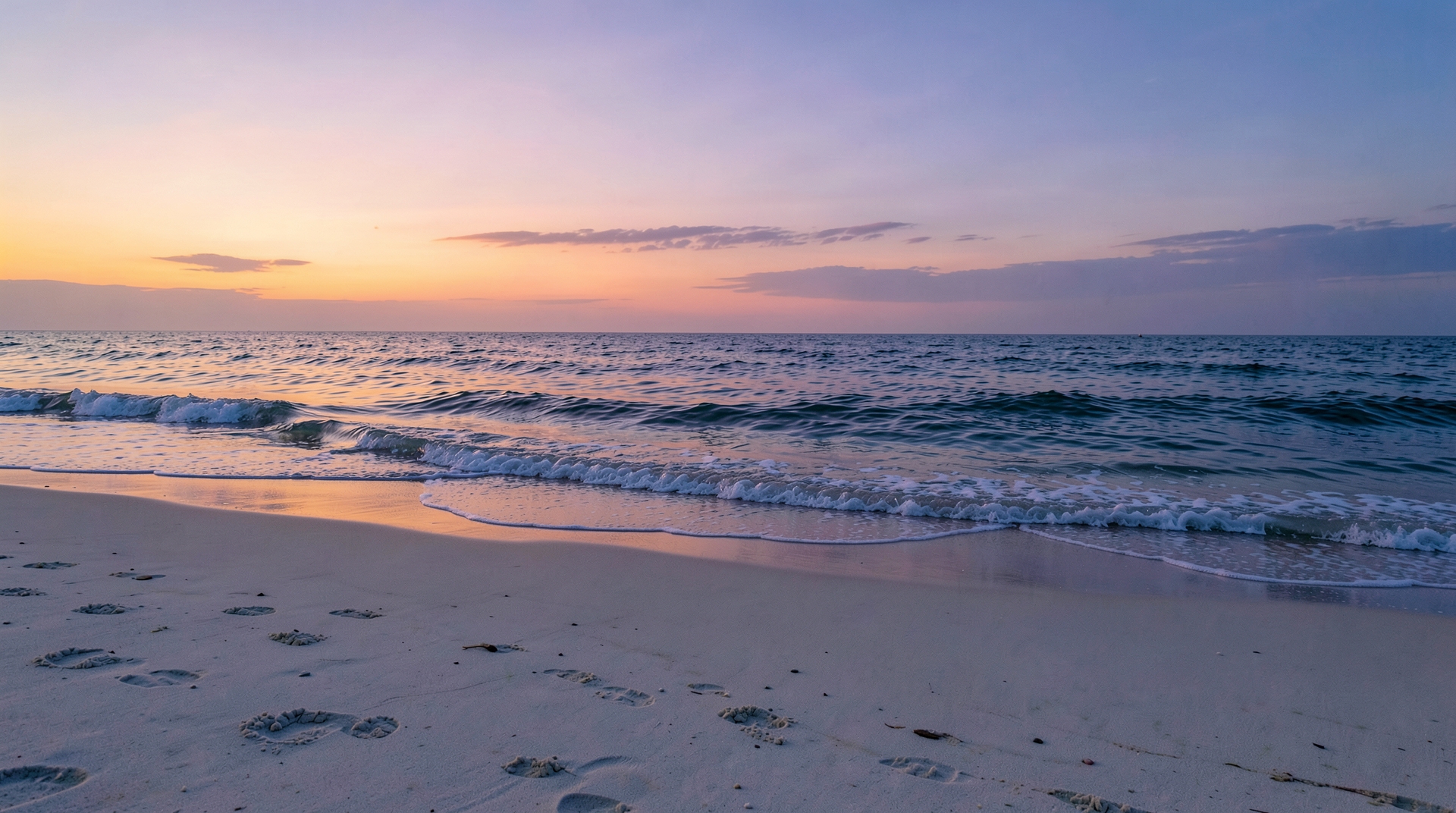 A peaceful beach at twilight hour, with warm lighting and gentle waves.