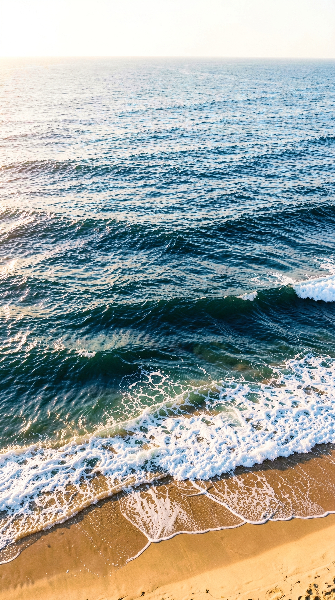 Aerial View of Ocean Waves on Sandy Beach
