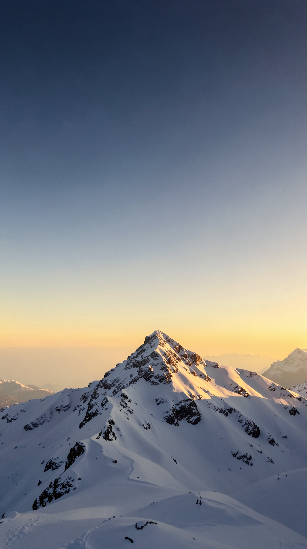 Snowy mountain peak at dawn