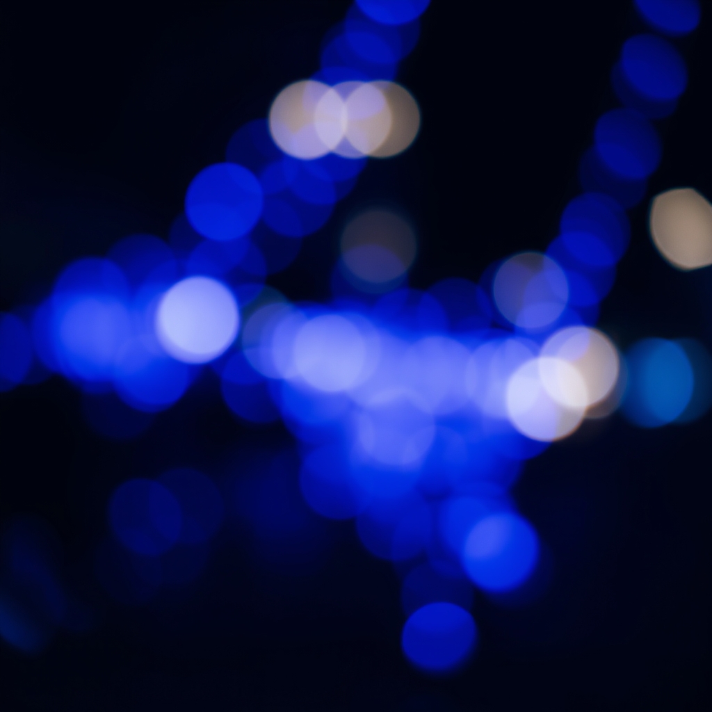 Vibrant Blue Bokeh Lights in Dark Background