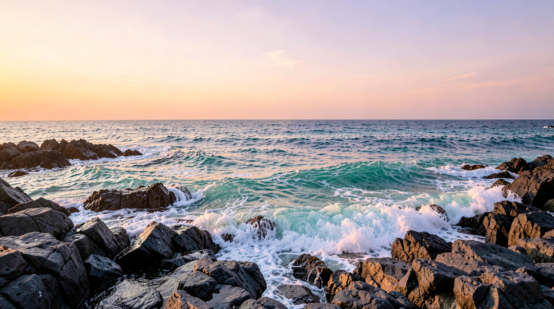 Waves Crashing on Rocky Shoreline at Sunrise